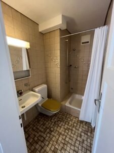 Clean bathroom with shower and white tiles