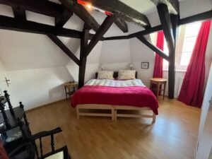 Bright living room with large window in Neuchâtel studio apartment