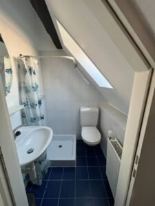 Clean bathroom with shower and white tiles